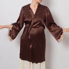 Vintage Romantic Short Satin Silk Robe with Bell Sleeve and Lace details, comes without a belt. Very Good Condition, like new. Medium Size, see the meassures below m e a s u r e m e n t s (taken while the item is lying flat): Shoulder: 16.5" / 42 cm Around Armpits: 40.9" / 104 cm Waist: 42.5" / 108 cm Hips: 42.5" / 108 cm Length: 38.6" / 98 cm Sleeve Length: 22" / 56 cm (Measurements of armpit, waist, and hips are doubled) Model is 170 cm or 5.5 feet tall, wears size available. We Offer: * World Silk Satin Finish Robe For Loungewear, Silk Robe With Satin Finish For Sleep, Brown Silk Robes, Victorian Robe Silk Satin, Elegant Silk V-neck Robe, Robes Silk, Short Satin, Silk Dressing Gown, Vintage Short