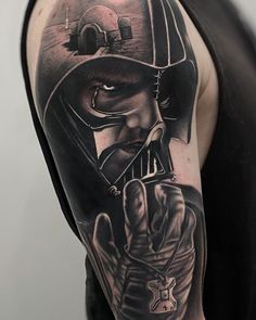 a man's arm with a star wars tattoo on it and a darth vader