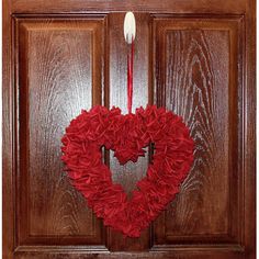 a heart shaped wreath hanging on the front door