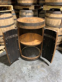 an old wooden table surrounded by wine barrels