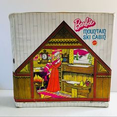 an old fashioned dollhouse with a woman in it