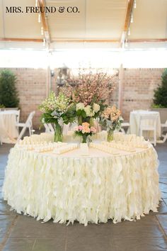 a table with flowers and candles on it