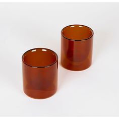 two brown glass cups sitting next to each other