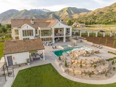 an aerial view of a large home with a pool and hot tub in the yard