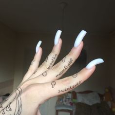 a person's hand with white nails and writing on the thumbnails that read sweetener