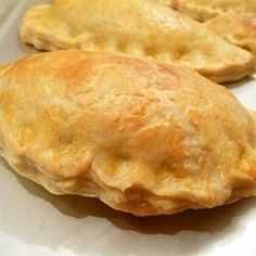 three pastries sitting on top of a white plate