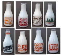 six different types of glass milk bottles with labels on them, all labeled in orange and white