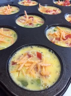 a muffin tin filled with cupcakes covered in cheese and toppings,