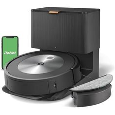 the robot vacuum is next to an electronic device