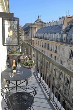 a balcony with tables and chairs on it