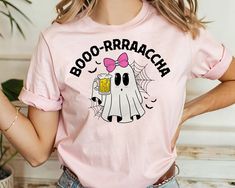 a woman wearing a pink boo - raracch t - shirt