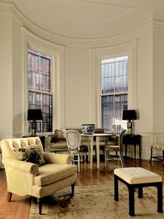 a living room filled with furniture and windows