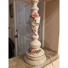 a lamp that is sitting on top of a counter next to a door in a house