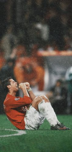 a man sitting on top of a soccer field