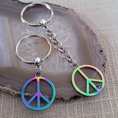 two key chains with peace signs on them