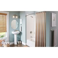 a bathroom with blue walls and white fixtures