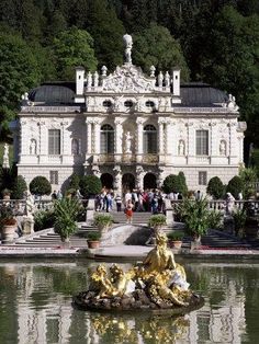 a fountain in front of a large white building