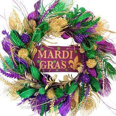 a mardi gras wreath with purple, green and gold decorations on it's side