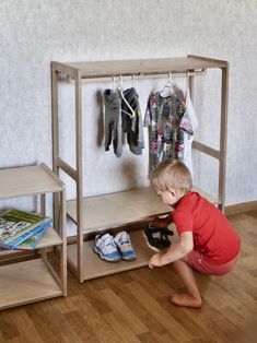 a little boy playing with his toys in the living room, while looking at it