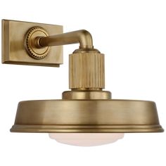 an antique brass finish wall light with a white glass shade on the top and bottom