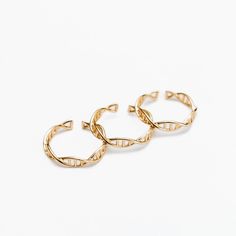 two gold hoop earrings on a white background