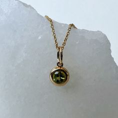 Materials: 14k Gold Gemstone: Genuine Peridot  Total Peridot Carat Weight: 0.20 ct. Pendant Diameter: 11mm x 6mm (including bale) Necklace: Adjustable 16 and 18 inches with a lobster clasp. Chain Weight: 0.6mm 1.35 grams Description: Option for pendant only, necklace available as an add on. The necklace is 16 and 18 inches adjustable, with a lobster clasp at the end. A beautiful round peridot in a bezel setting.  This beautiful piece will not tarnish in the shower and will not irritate the skin. It will arrive in a jewelry box, with a jewelry bag for traveling. Perfect for gift giving! Feel free to message me with any questions! I will respond within 12 hours. Yellow Gold Polished Peridot Jewelry, Yellow Gold Peridot Jewelry With Polished Finish, Round Cut Peridot Jewelry In Yellow Gold, Gift Yellow Gold Peridot Gemstones, Round Peridot Gemstones Fine Jewelry, Locket Earrings, Temple City, Whimsical Jewelry, Peridot Pendant