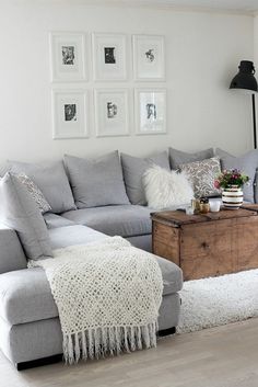 a living room filled with furniture and pictures on the wall above it's coffee table