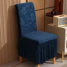 a blue chair sitting next to an old radio