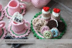 crocheted baby booties and cupcakes are on the floor next to each other