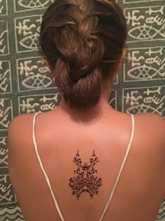 a woman with a tattoo on her back