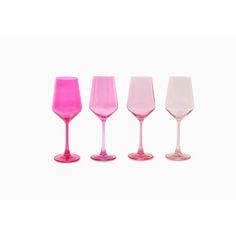 four different colored wine glasses sitting next to each other