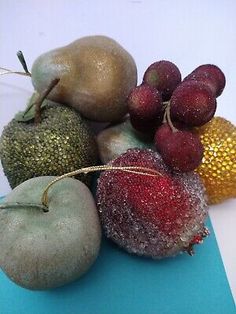 some fruit is sitting on top of a piece of blue paper with gold sequins