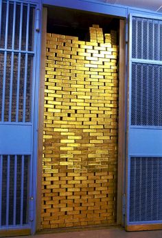 a bunch of gold bars are stacked into a door