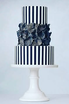 a black and white striped cake with flowers on top