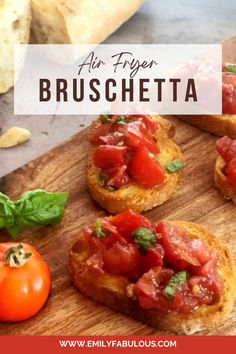 bruschetta with tomatoes and basil on a wooden cutting board next to bread