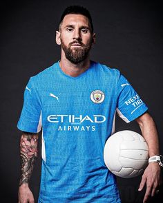 a man holding a soccer ball and wearing a blue shirt with white writing on it