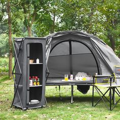 an outdoor tent set up in the grass