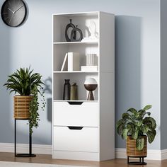 a white bookcase with two plants and a clock