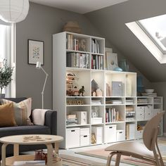 a living room filled with furniture and lots of bookshelves on top of it