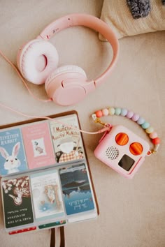 headphones, books, and other items are on the floor next to each other