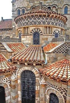 an old building with tiled roof tops and arched doorways in the middle of it