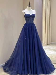 Boldly step into the spotlight with this exquisite navy blue gown. The dress features a beautifully beaded bodice that sparkles with every turn, creating an eye-catching effect. The sweetheart neckline and slender spaghetti straps provide a delicate and feminine touch. Flowing from the waist is a full tulle skirt that adds volume and elegance, ensuring you make a grand entrance at any event. Perfect for proms, weddings, or any formal affair, this dress is designed to highlight your sophistication and charm. Pair it with shimmering accessories and stylish heels to complete a look that is both graceful and glamorous. This gown is a must-have for anyone looking to make a stunning impression and feel like royalty for the night. Prom Silk Dress Satin, Not Basic Prom Dresses, Dark Blue Sweet 16 Dress, Grad Dresses Dark Blue, Midnight Blue Long Dress, Cheap Prom Dresses Long Under 100, Prom Dress Ideas 2025, Homemade Prom Dress Diy, Prom Dresses Blue Sparkly