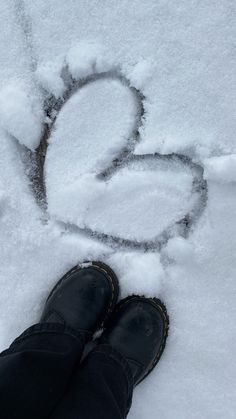 someone is standing in the snow with their feet up and writing on the snow covered ground