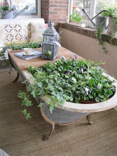 a table that has some plants in it and a lantern on the top of it