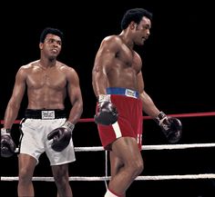 two men standing next to each other wearing boxing gloves