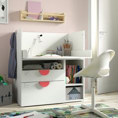 a child's room with pink walls and white furniture