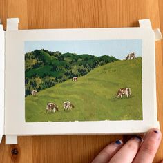 a painting of cows grazing in a green field