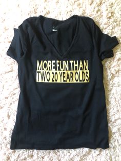 a black shirt that says more fun than two 20 year olds