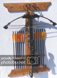 an arrow and bow rack mounted to the side of a wall