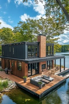 a house that is sitting on top of a wooden dock next to water and trees